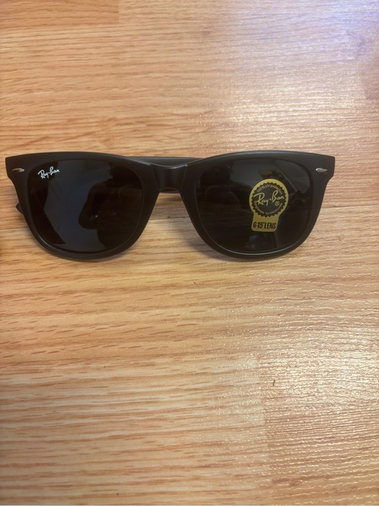 Ray-Ban Other - Sunglasses on wooden surface